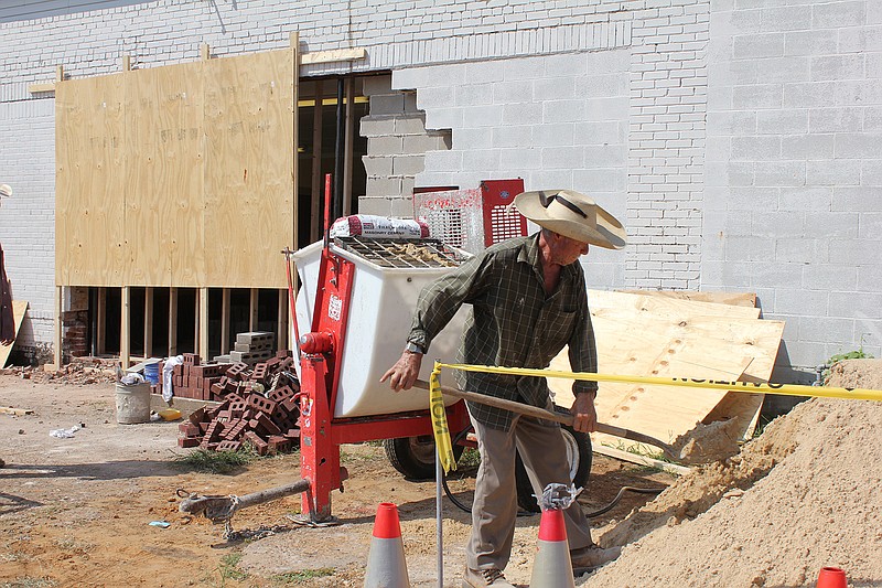 Julio (no last name) mixes concrete on Thursday to repair the side wall of the American Legion Post 2558 building. The building's wall facing Laurel Street was heavily damaged on July 1 when a vehicle left Broad Street and hit the American Legioin's exterior wall at a high rate of speed. Steel poles had to be installed to brace the building, which was constructed in 1919. Because the building, located at 525 Broad St., is historic, building codes require the repair work to resemble as closely as possible the structure's original state. 413 Construction Partners LLC is doing the work.
