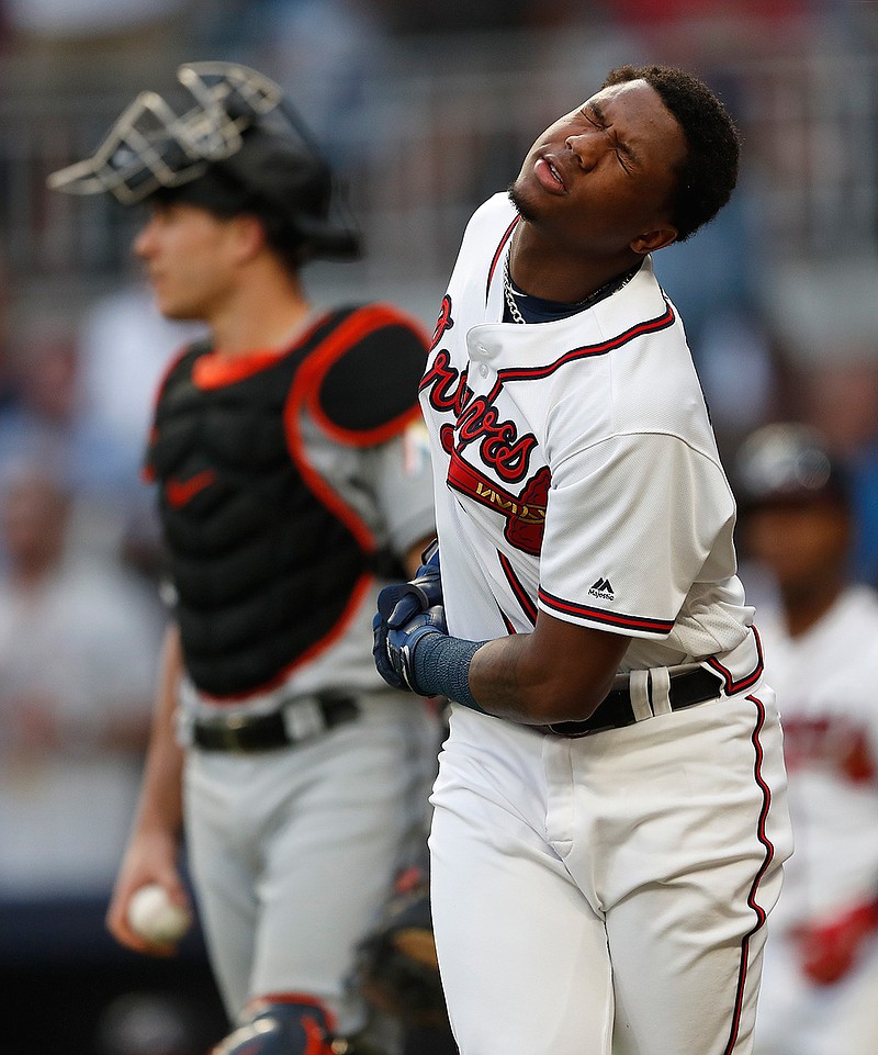 Atlanta Braves left fielder Ronald Acuna Jr. (13) reacts after being hit by a pitch from Miami Marlins starting pitcher Jose Urena in the first inning of a baseball game Wednesday, Aug. 15, 2018, in Atlanta. (AP Photo/John Bazemore)