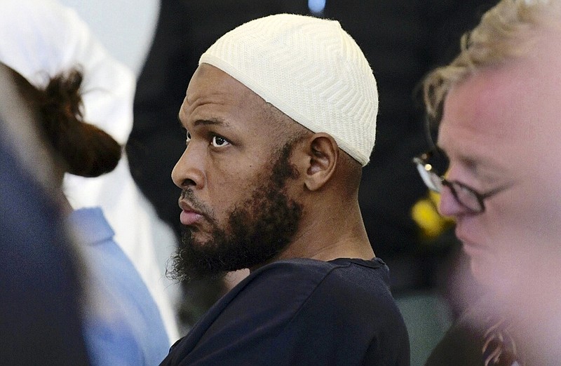 In this Monday, Aug. 13, 2018, file photo defendant Siraj Ibn Wahhaj sits in court in Taos, N.M., during a detention hearing. New Mexico forensic investigators announced Thursday, Aug. 16, that a highly decomposed body found at a desert compound in New Mexico has been identified as a missing Georgia boy with severe disabilities. The New Mexico Office of the Medical Investigator said Thursday that the remains were those of Abdul-ghani Wahhaj. (Roberto E. Rosales/The Albuquerque Journal via AP, Pool, File)