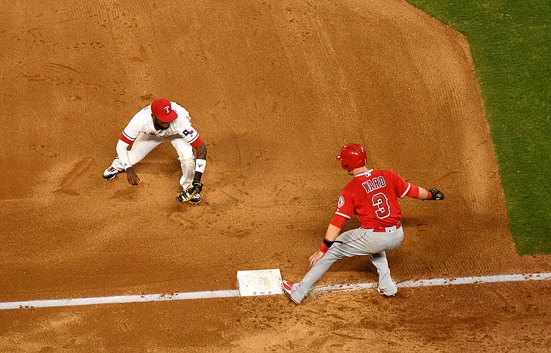 Texas Rangers shortstop Jurickson Profar runs to tag out Los Angeles Angels' Taylor Ward (3) for one out of a triple play on a ground ball by David Fletcher off of Texas Rangers starting pitcher Ariel Jurado during the fourth inning of a baseball game, Thursday, Aug. 16, 2018, in Arlington, Texas. Fletcher and Eric Young Jr. were also out on the play. (AP Photo/Jeffrey McWhorter)