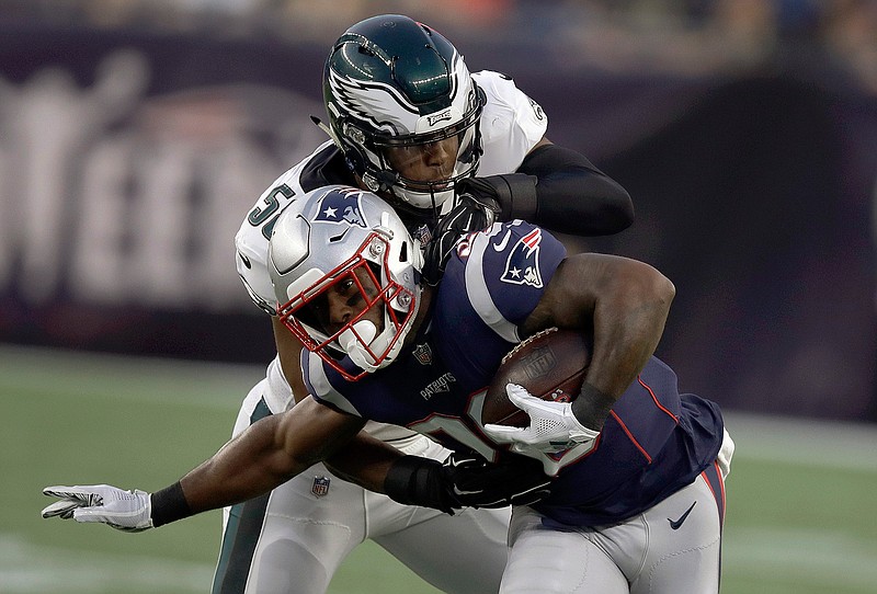 Philadelphia Eagles linebacker Jordan Hicks, rear, tackles New England Patriots running back James White during the first half of a preseason NFL football game, Thursday, Aug. 16, 2018, in Foxborough, Mass. (AP Photo/Charles Krupa)