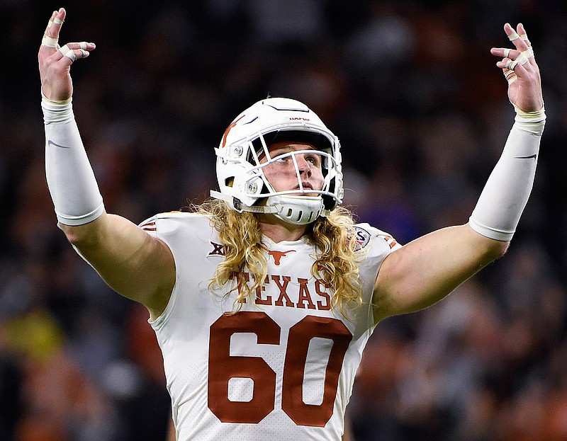 In this Dec. 27, 2017 file photo, Texas linebacker Breckyn Hager gestures to the crowd before a third-down play during the second half of the Texas Bowl NCAA college football game against Missouri in Houston. The frustration at Texas is visible in Hager's flowing golden curls. Hager was a freshman when he vowed he wouldn't cut his hair until Texas won the Big 12. (AP Photo/Eric Christian Smith, file)