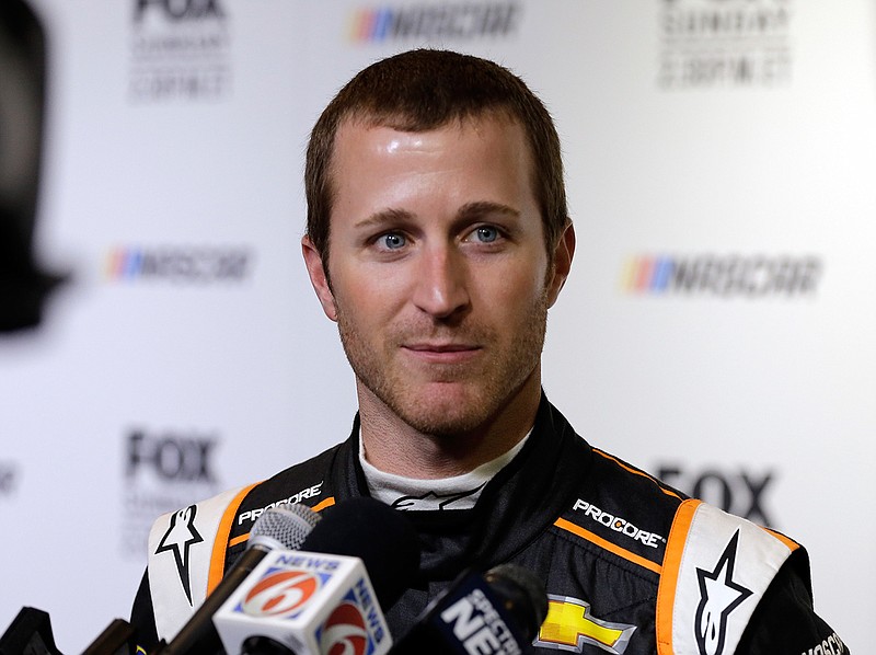 In this Feb. 14, 2018, file photo, Kasey Kahne speaks during media day for the NASCAR Daytona 500 auto race at Daytona International Speedway in Daytona Beach, Fla. Kahne says he is retiring from full-time racing. The 38-year-old Kahne announced his intentions Thursday, Aug. 16, 2018, on Twitter, saying "I'm not sure what the future holds for me, but I'm at ease with the decision that I have made."(AP Photo/Terry Renna, File)