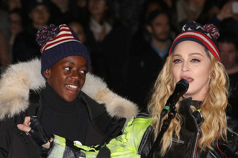 In this Nov 7, 2016 file photo, U.S. Singer Madonna, right, and her son David Banda perform in support of Democratic presidential candidate Hillary Clinton at Washington Square Park. The Queen of Pop is also a soccer mom and she's getting ever more involved in the beautiful game. Madonna has plans to open a soccer academy in Malawi, inspired by her adopted son David Banda who has ambitions to be a professional player and is at Portuguese club Benfica's youth academy. (Photo by Greg Allen/Invision/AP file)