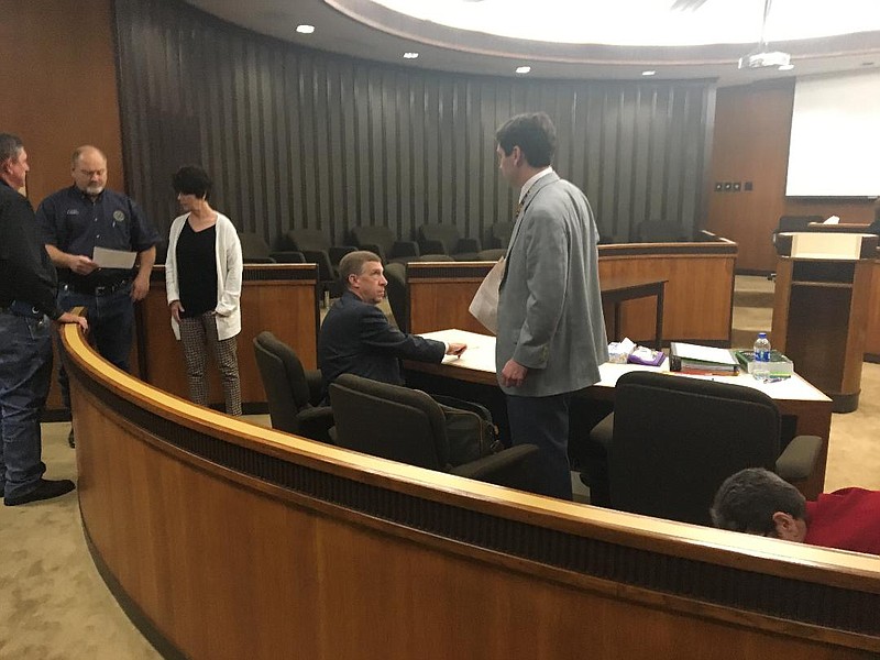 Todd Peck, seated, speaks with a member of his defense team Thursday while waiting for a jury to return a verdict in the guilt/innocence phase of his child sex abuse trial. The jury found Peck guilty and later returned a sentence of life without the possibility of parole.