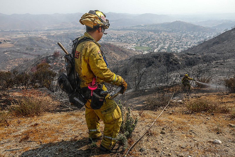 Cal Fire firemen taking care of few hot spots from the Holy fire in McVicker Canyon neighborhood of Lake Elsinore, Calif., on Saturday, Aug. 11, 2018. (Irfan Khan/Los Angeles Times/TNS)