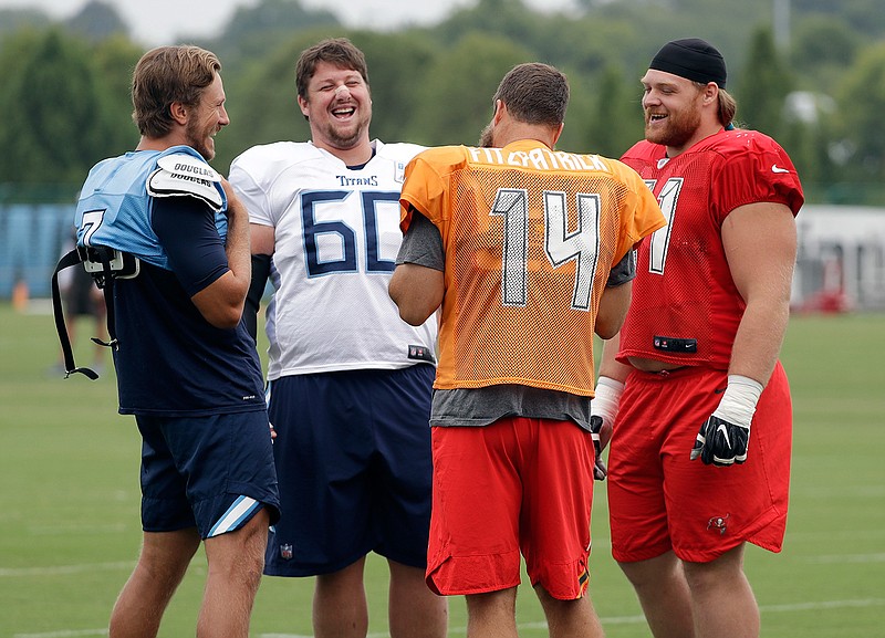 Tennessee Titans quarterback Blaine Gabbert (7), left, and center Ben Jones (60) talk with Tampa Bay Buccaneers quarterback Ryan Fitzpatrick (14) and defensive tackle Beau Allen (91) during a combined NFL football training camp Thursday, Aug. 16, 2018, in Nashville, Tenn. (AP Photo/Mark Humphrey)