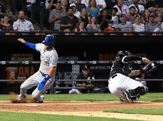 Whit Merrifield of the Royals is safe at home as White Sox catcher Omar Narvaez takes a late throw during the third inning of Friday night's game in Chicago.