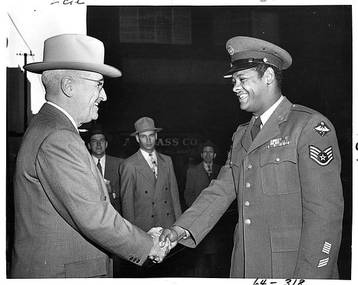 U.S. Air Force Staff Sgt. Edward Williams (right) shakes hands with President Harry S. Truman at a casual meeting during the president's morning walk. (Harry S. Truman Library and Museum.)