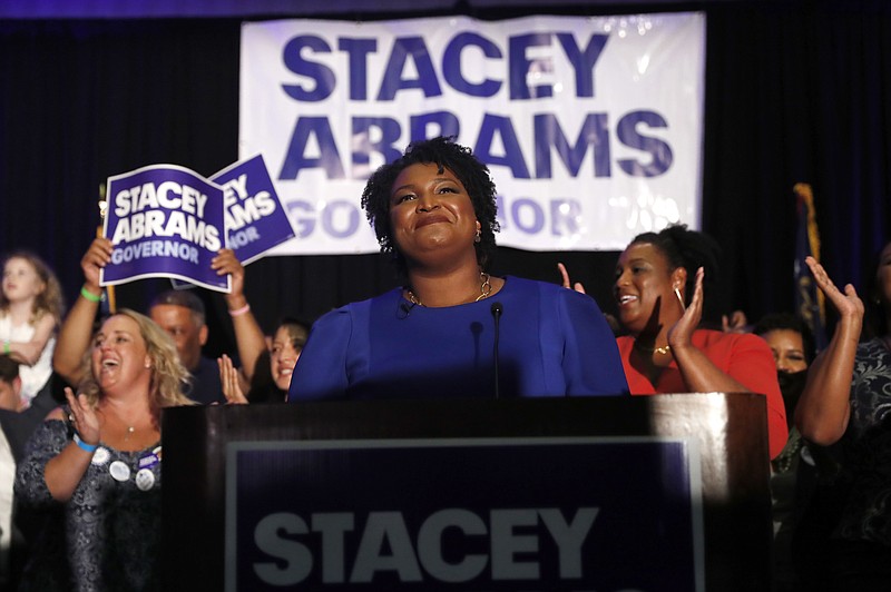 FILE - In this May 22, 2018, file photo, Georgia Democratic gubernatorial candidate Stacey Abrams smiles before speaking to supporters during an election-night watch party in Atlanta. More women than ever before have won their primaries for governor, U.S. Senate and House this year. That’s setting a record and paving the way for battles in November that could significantly increase the number of women in elected office. (AP Photo/John Bazemore, File)