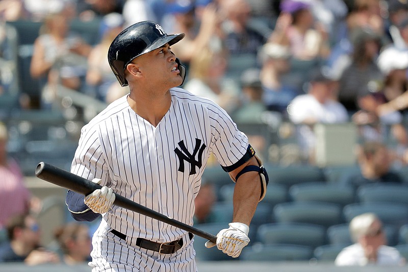 New York Yankees' Giancarlo Stanton watches his solo home run off Toronto Blue Jays starting pitcher Sean Reid-Foley during the fourth inning of a baseball game, Saturday, Aug. 18, 2018, in New York. (AP Photo/Julio Cortez)
