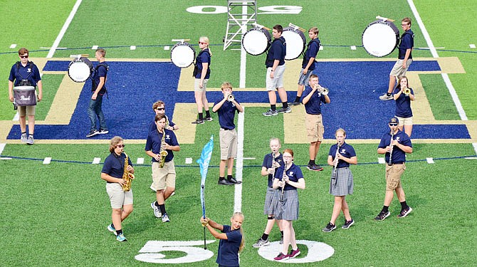 The Marching Crusaders band perform their preview show Saturday for their fans in attendance at Helias Catholic High School to kick off a new school year. 