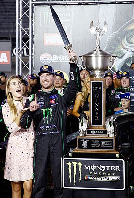 Kurt Busch celebrates with his wife, Ashley Van Metre, after winning the NASCAR Cup Series race Saturday night in Bristol, Tenn.