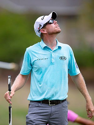 David Hearn looks up at darkening skies after a horn sounded suspending play during Saturday's third round of the Wyndham Championship in Greensboro, N.C.