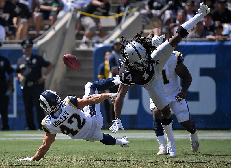 Los Angeles Rams defensive back Nate Holley breaks up a pass intended for Oakland Raiders wide receiver Keon Hatcher during the second half in an NFL preseason football game Saturday, Aug. 18, 2018, in Los Angeles. (AP Photo/Mark J. Terrill)