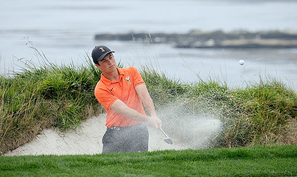 Viktor Hovland watches his shot out of a bunker to the fourth green of the Pebble Beach Golf Links during Sunday's title match of the U.S. Amateur in Pebble Beach, Calif.