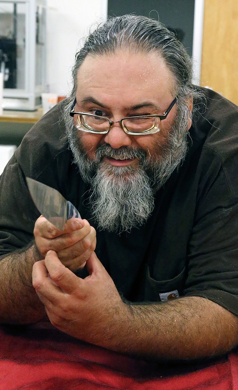 Tobin Nieto checks the lines of a creation as he teaches a class in bladesmithing July 17, 2018, at the Southwest School of Art in San Antonio. 