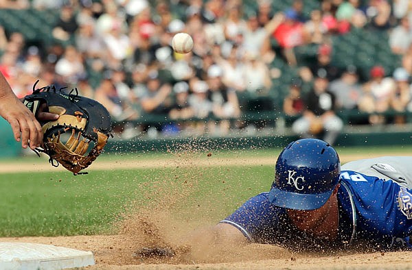 White Sox first baseman Jose Abreu waits for a throw as Brett Phillips of the Royals dives back into the bag during the eighth inning of Sunday afternoon's game against the White Sox in Chicago. Phillips was out on the play.