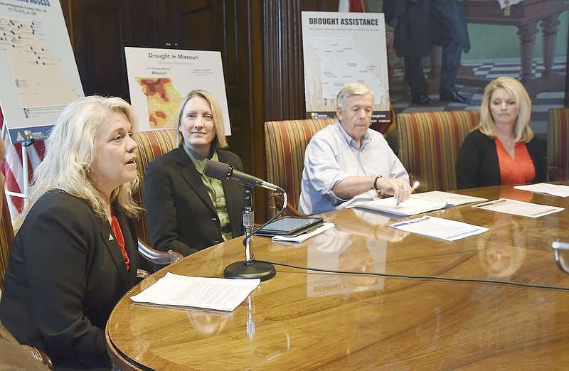 Directors of multiple state agencies and representatives of farming associations met with Gov. Mike Parson, second from right, Monday in his Capitol office to deliver an update on drought conditions and the ways state agencies are offering assistance. Sara Pauley of Missouri Department of Conservation, speaking, stated the MDC is opening up access to water for farmers to be able to haul for their use. Seated second from left is Carol Comer, director of Department of Natural Resources and at right is Missouri Department of Agriculture Director Chris Chinn. 