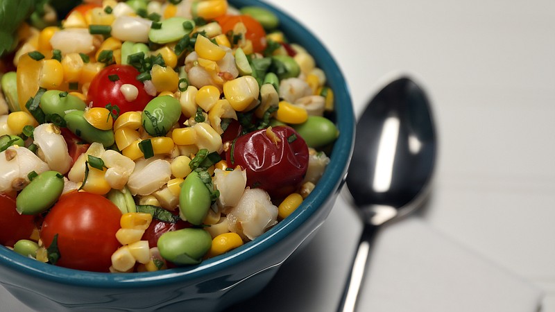 This fresh corn salad uses Peruvian corn, called choclo, which has a toothsome texture. (Terrence Antonio James/Chicago Tribune/TNS)