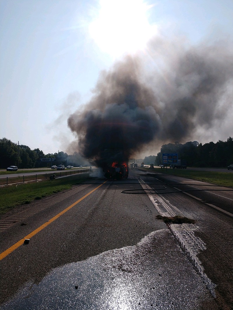 Crews work to extinguish flames in a pickup that was set ablaze Tuesday, Aug. 21, 2018, after a tractor-trailer rear-ended it, causing it to strike another tractor-trailer. The pickup's driver suffered only minor injuries in the accident at the 219-mile marker between Texarkana and Nash, Texas, said Shawn Vaughn, spokesman for Texarkana, Texas, Police Department. Traffic was rerouted onto U.S. Highway 82 for several hours after the accident.
(Photo courtesy of Texarkana, Texas, Police Department)