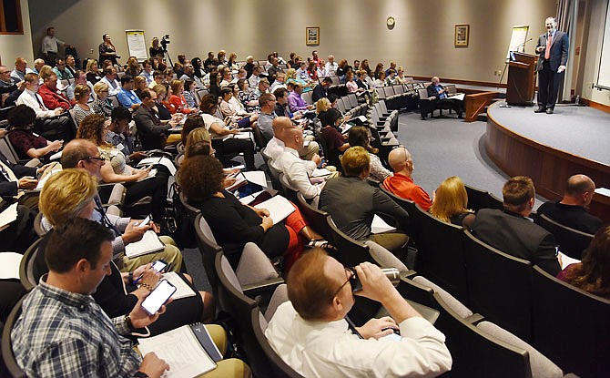 Attendees to Tuesday's conference at the Runge Center got out their cellphones to respond to a survey on the screen before them. They were in the center's auditorium for the Missouri Way training, a three-day conference aimed at improving the leadership of state agency administrators and supervisors.