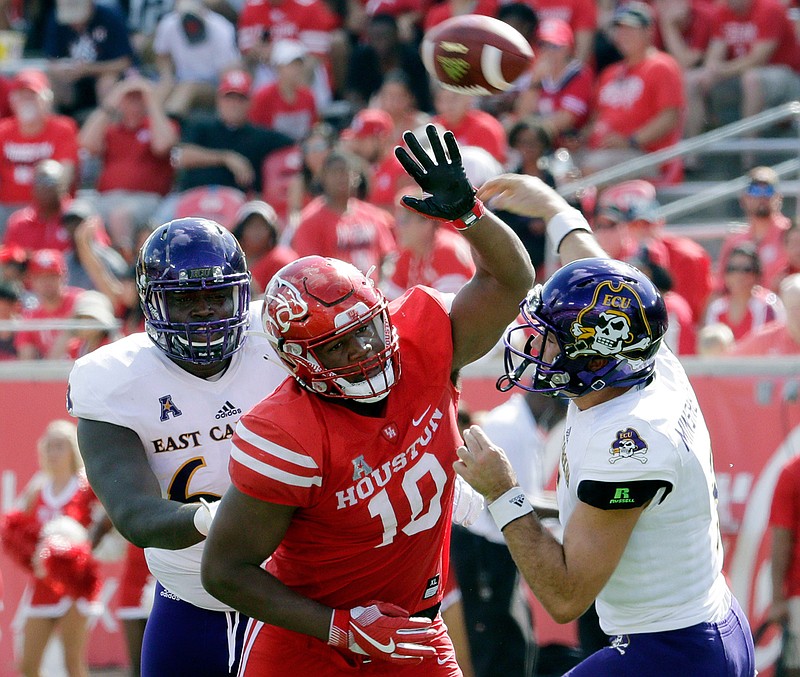 In this Nov. 4, 2017, file photo, Houston defensive tackle Ed Oliver (10) tries to break up a pass by East Carolina quarterback Gardner Minshew (5) during the first half of an NCAA college football game, in Houston. Oliver was selected to the AP Preseason All-America team, Tuesday, Aug. 21, 2018. (Michael Wyke/Houston Chronicle via AP, File)