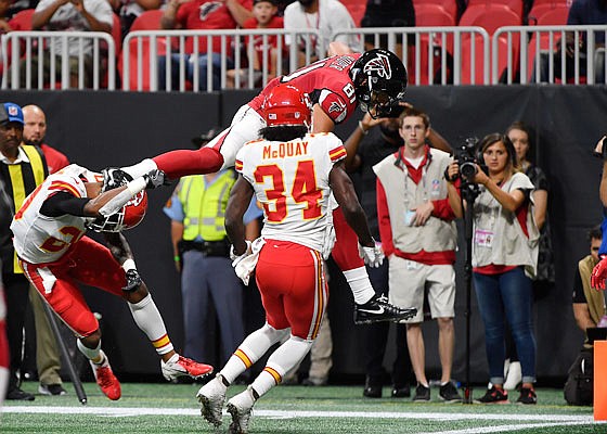 Falcons tight end Austin Hooper makes it into the end zone for a touchdown as Chiefs defensive back Leon McQuay tries to move in for a tackle during last Friday night's exhibition game in Atlanta.