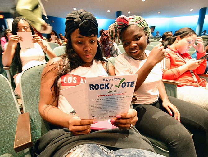 Lincoln University freshmen Deonna West, left, and Lauren Butler review election literature Wednesday during Blue Tigers Rock the Vote 2018 event at Pawley Theater. The event is part of WOW Week, which welcomes new students and encourages them to vote.