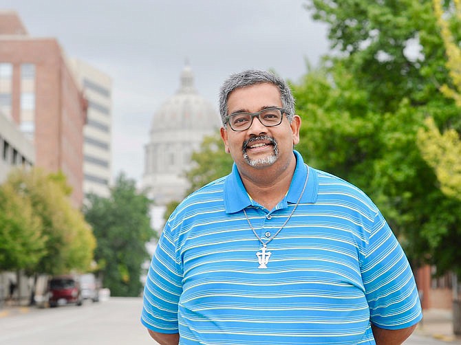 The Rev. Rushan Sinnaduray, pastor of the newly established Oasis United Church of Christ, poses on Capitol Avenue in downtown Jefferson City.