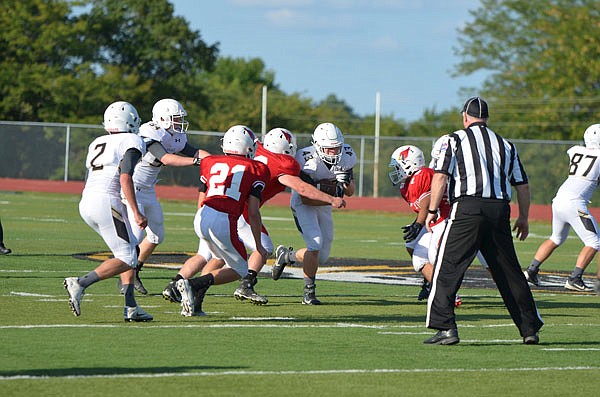 The Versailles Tigers run a play during last Friday's Jamboree against the Tipton Cardinals in Versailles.