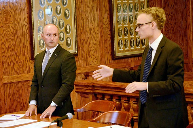 Deputy Solicitor Peter Reed, right, speaks to Judge Pat Joyce Friday while he stands next to attorney Timothy Van Ronzelen, representing former Trooper Anthony Piercy, during a hearing in which the state asked Joyce to amend her original order telling the Highway Patrol to re-instate Piercy to his job. 