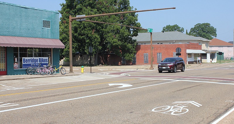 A car enters the intersection of Texas Boulevard and West Fourth Street on Friday in Texarkana, Texas. The bicycle symbol painted on the pavement is called a sharrow. It signals that drivers and cyclists should share the road. It does not indicate a lane dedicated only to bike traffic.