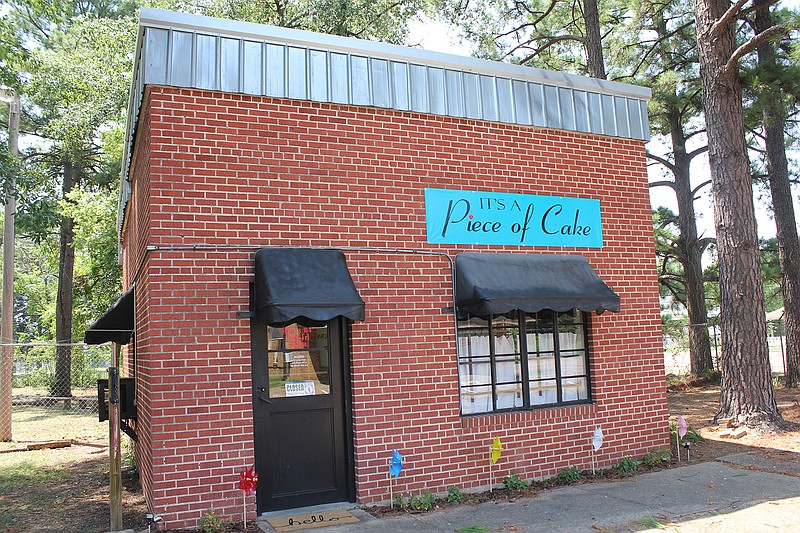 The small square red-brick building at 419 Main St. in Texarkana, Texas, that was once a dress shop and a law office will now house A Piece of Cake, a shop specializing in baked desserts.