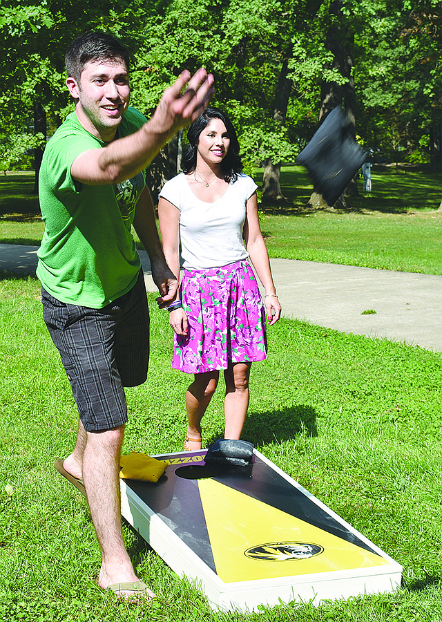 Dan Kalaf of the band Minor Inconvenience plays a game of cornhole with his girlfriend, Ashley Moore, after his band played a set at Sunday's second annual Veterans Appreciation in the Park event at Memorial Park.