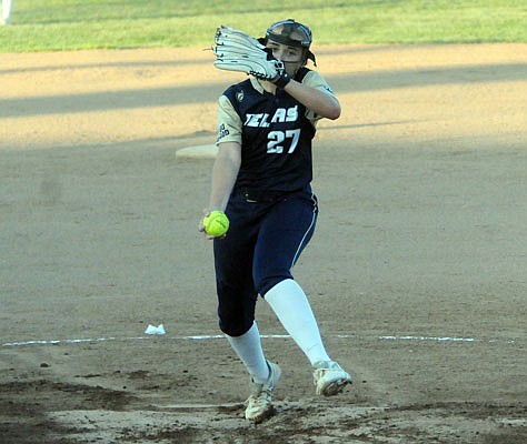 Helias junior Lauren Howell works to the plate in the first inning of Tuesday night's game against the Battle Spartans at the American Legion Post 5 Sports Complex.