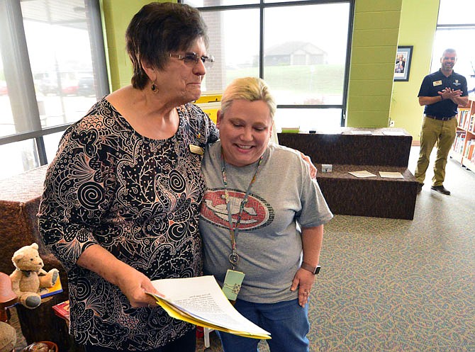 Ashley Angle, right, a kindergarten teacher at Pioneer Trail Elementary School, is presented with an award Wednesday from Georgia White of the Missouri Retired Teacher Association.
