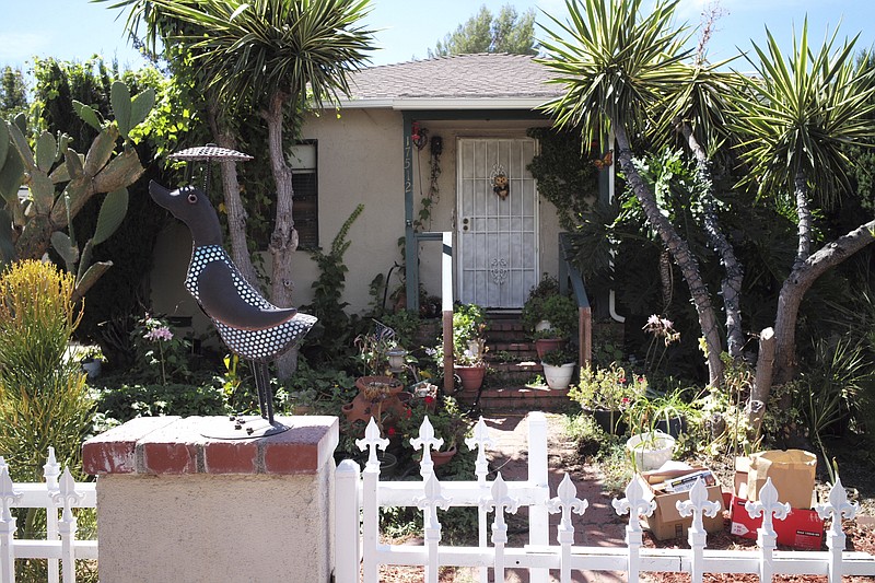 Surrounded by a white picket fence, this photo shows the front entrance of Robert Chain's house in the Encino section of Los Angeles on Thursday, Aug. 30, 2018. Chain, who was upset about The Boston Globe's coordinated editorial response to President Donald Trump's attacks on the news media, was arrested Thursday for threatening to travel to the newspaper's offices and kill journalists, whom he called the "enemy of the people," federal prosecutors said. (David Crane/Los Angeles Daily News via AP)