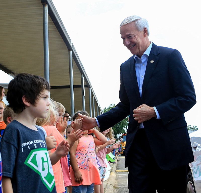 Arkansas Gov. Asa Hutchinson shakes the hands of students at Genoa Elementary School on Tuesday in Genoa, Ark. Hutchinson stopped by the school as part of his fall 2018 computer science tour.