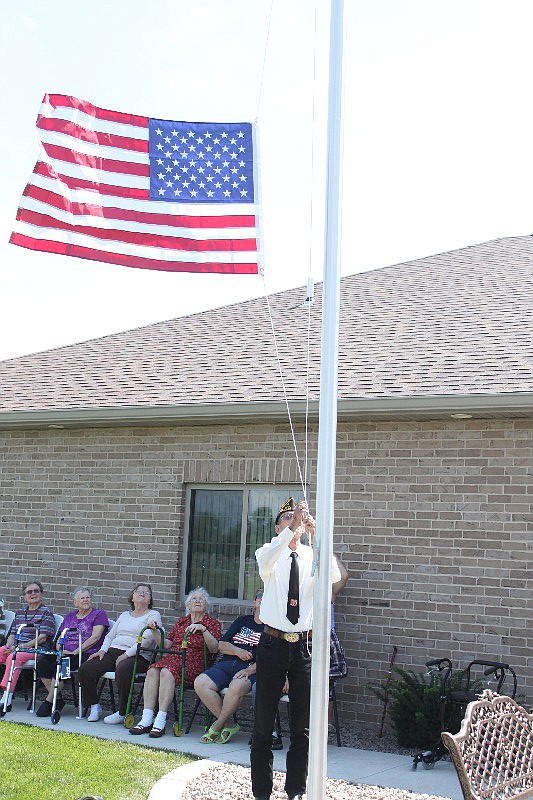 George Shelley, of the VFW Memorial Post 4345, raises a flag Sept. 1 at Valley Park Retirement Home.