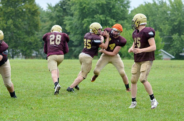 Logan Hall (28) of the Mustangs runs the ball during a practice session last month in Eldon.