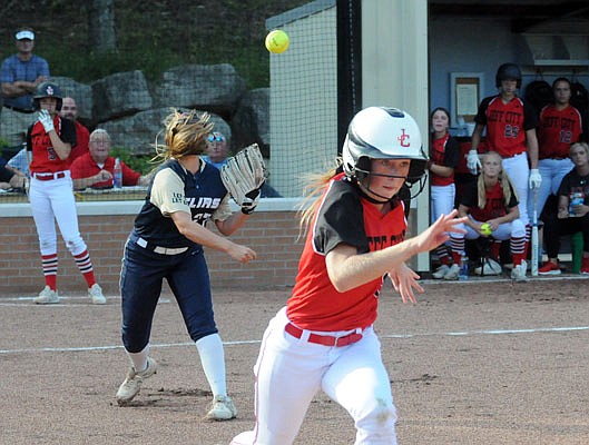 Helias pitcher Lauren Howell throws to first to get Brooke Bates of Jefferson City during Wednesday's game at Riverside Park.