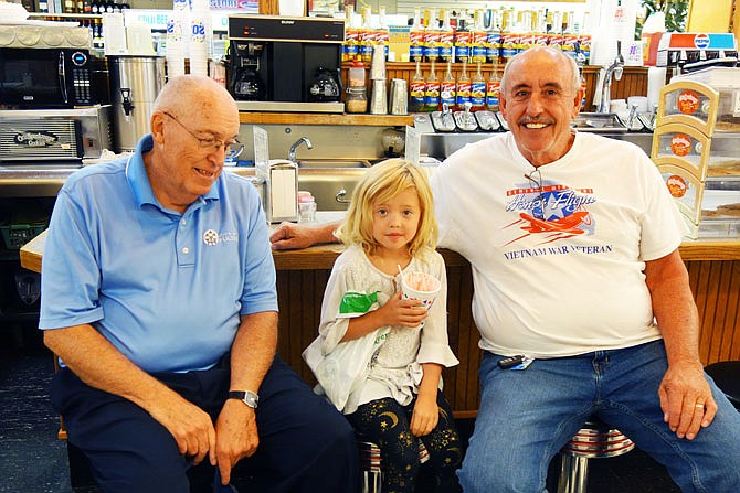 Taylor Duncan, center, enjoyed a strawberry sundae at Saults Drug Store with Fulton Mayor LeRoy Benton, left, and Auxvasse Mayor Tom Henage. The 5-year-old grilled the two on issues like the environment.