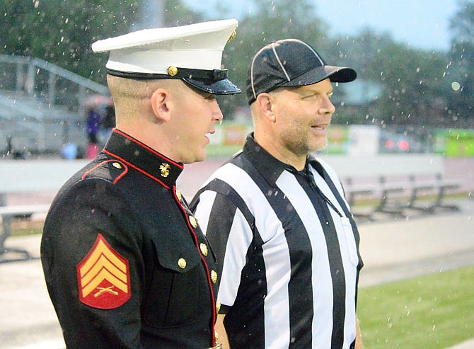 Marine Sgt. Stephen Woodward, attending the Great American Rivalry Series between Hickman and Jefferson City high schools at Adkins Stadium on Friday evening, chats with official Don Baumann. The second oldest rivalry West of the Mississippi, Hickman vs. Jefferson City has been an ongoing rivalry since the two teams played for the first time in 1911. This year marks the 115th meeting of these two teams.