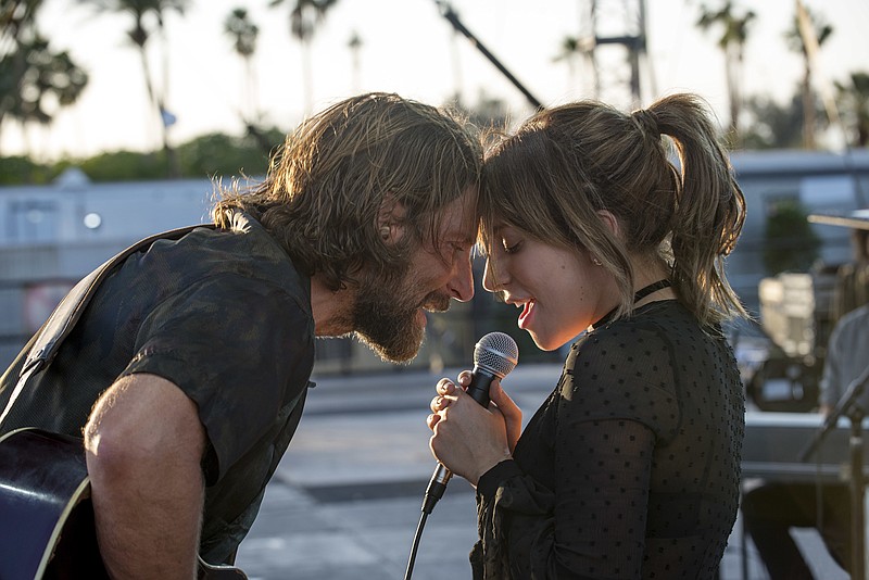 This image released by Warner Bros. shows Bradley Cooper, left, and Lady Gaga in a scene from the latest reboot of the film, "A Star is Born." (Neal Preston/Warner Bros. via AP)