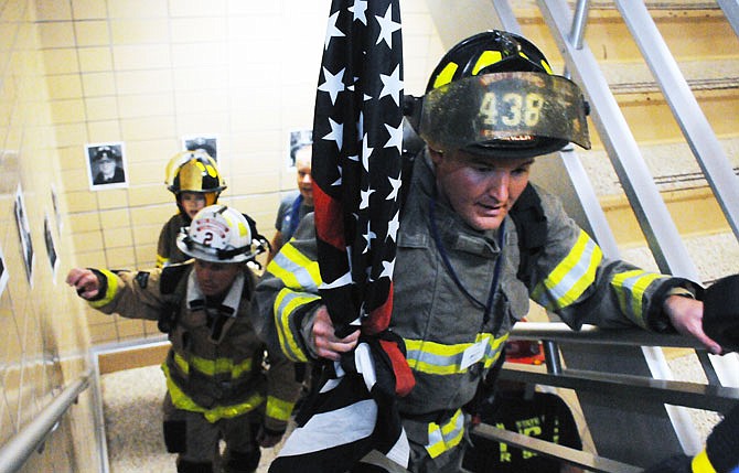 Participants in the 2018 Missouri State Fire Marshal 9/11 Memorial Stair Climb make their way up the 2,600 stairs Saturday at the Jefferson State Office Building in honor of the firefighters who lost their lives on Sept. 11, 2001. The pictures of the fallen lined the stairwells. 
