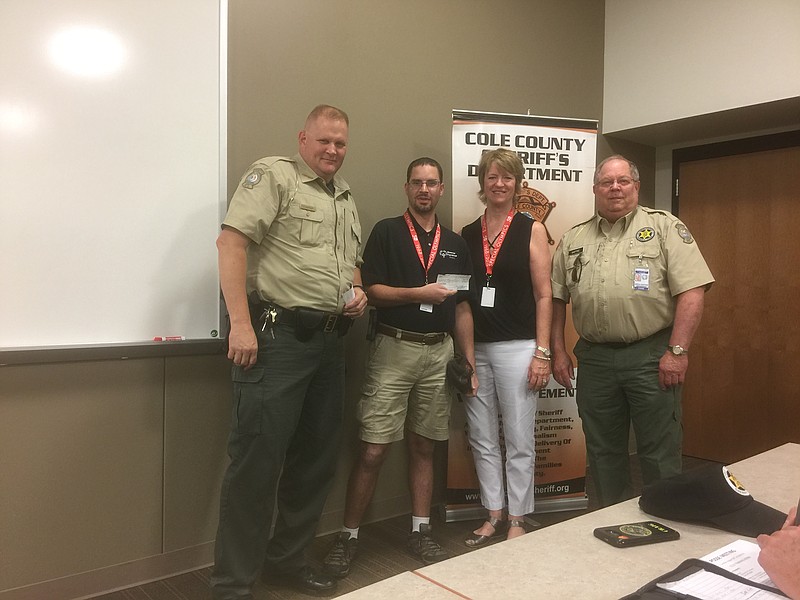 <p>Submitted</p><p>Greg Gaffke, right, president of the Cole County Sheriff’s Posse Association, presents a $500 donation to Susan Stegeman, Special Olympics Missouri VP of Development and Derick Sandbothe, campus host for the Special Olympics Missouri Training Center for Life campus.</p>