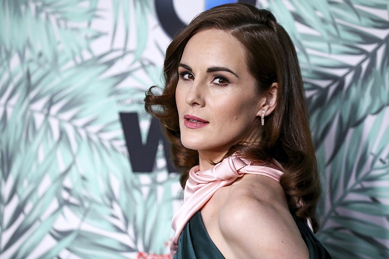 FILE - In this Feb. 24, 2017, file photo, Michelle Dockery arrives at the 10th Annual Women in Film Pre-Oscar Cocktail Party at Nightingale Plaza in Los Angeles. Filming has begun for the “Downtown Abbey” movie. Dockery, who plays Lady Mary in the global hit, posted a photo on Instagram with the caption, “And...we’re off.” (Photo by Rich Fury/Invision/AP, File)