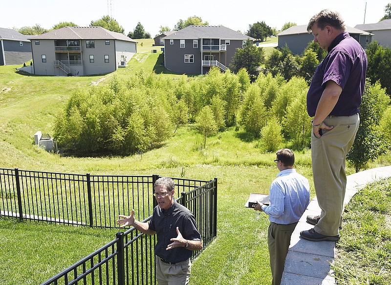 Julie Smith/News Tribune
Several Jefferson City councilmen joined city public works staffers Britt Smith, at right, and David Bange, lower left,  on an August 2017 bus tour of stormwater trouble spots in town. Homes in low-lying areas have water runoff issues in heavy rains, which cause either flooding in their yards or sometimes, in their homes. Public works officials talked about improvements they've made in some areas as they try to take on the mose troublesome areas first and work their way to others. 