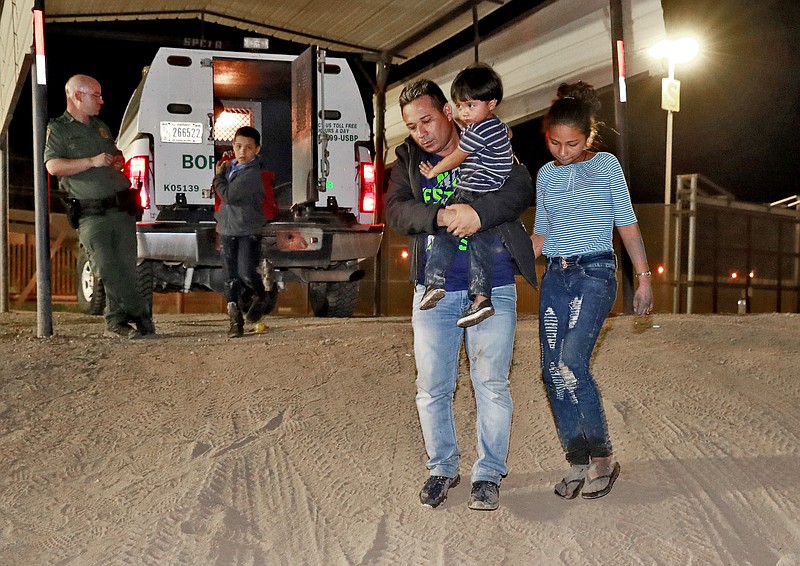  In this July 18, 2018 file photo, a Honduran man carries his 3-year-old son as his daughter and other son follow to a transport vehicle after being detained by U.S. Customs and Border Patrol agents in San Luis, Ariz. Border arrests figures for August 2018, are the latest reminder of how crossings have shifted over the last decade from predominantly Mexican men to Central American families and children. The number of family arrivals reached 15,955, a sharp increase from July that Customs and Border Protection Commissioner Kevin McAleenan said was one of the highest on record. (AP Photo/Matt York, File)